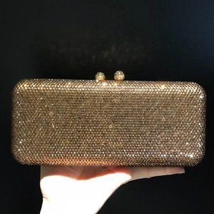 Sparkling gold evening clutch bag encrusted with rhinestones for elegant formal parties