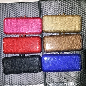 Detailed grid view of six colorful rhinestone evening clutch bags with round metal clasps