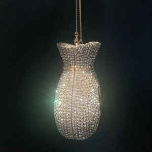 Detailed view of silver crystal rhinestones on a money bag luxury evening clutch bag