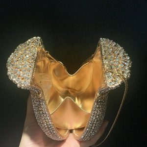 Close-up of money bag evening clutch showing sparkling silver rhinestones and gold lining