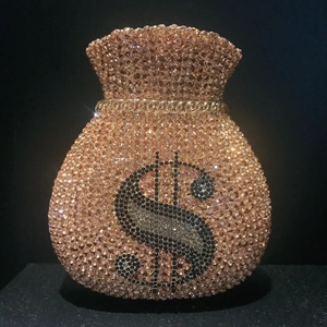 Macro view of crystal rhinestone money pouch clutch featuring a sparkling dollar sign