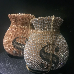 Detailed macro of gold and silver money bag clutch purses with sparkling dollar sign rhinestones