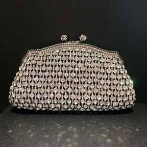 Macro shot of luxury clutch bag featuring crystal studs and crystal-studded spherical clasp