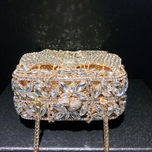 Luxury diamond bow clutch with crystal floral patterns and gold metal chain strap