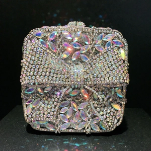 Macro detail of luxury evening clutch with sparkling crystals and bow pattern design