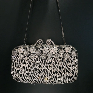 Elegant rectangular evening clutch with floral rhinestone patterns and metal chain strap