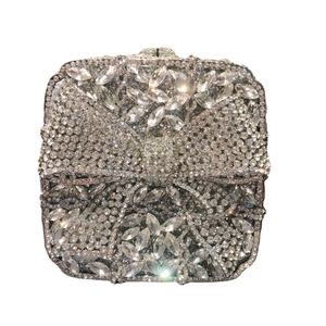 Sparkling white rhinestone clutch bag featuring a luxurious crystal bow design on the front