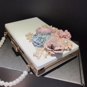 Elegant white floral clutch bag with 3D fabric flowers, pearls and gold branch accents