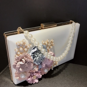 Detail of white PU clutch bag with 3D floral petals and elegant pearl gold branch decor