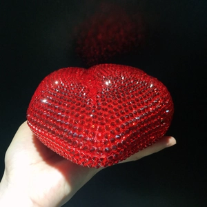 Close-up of red lip-shaped clutch bag encrusted with sparkling red crystals