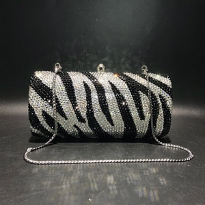 Detailed close-up of zebra pattern rhinestones and silver metal frame on the evening bag