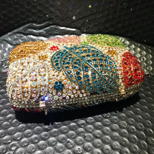 Nahaufnahme der luxuriösen Abendtasche mit Blattmuster und bunten Strasssteinen