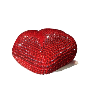 Sparkling red heart-shaped clutch bag covered in rhinestones for evening parties