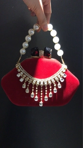 Red velvet shell evening clutch with pearl handle and crystal tassel details