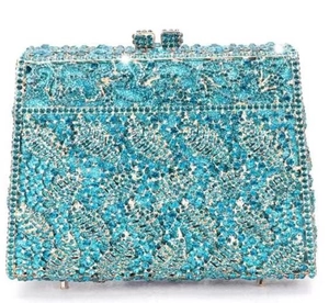 Close-up of hollow leaf pattern and blue rhinestones on the luxury clutch bag