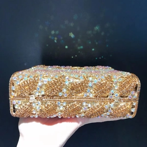 Detailed close-up of the hollow leaf diamond-set clutch with sparkling gold crystals