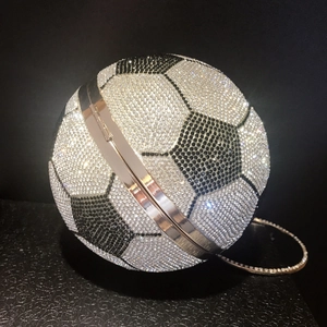 Spherical soccer clutch bag with black and white rhinestones and a silver chain strap