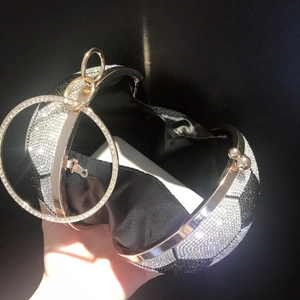 Macro view of crystal soccer ball evening bag with round handle and phone storage space