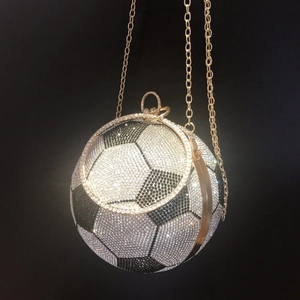 Detailed view of football evening bag with silver and black crystals and gold chain