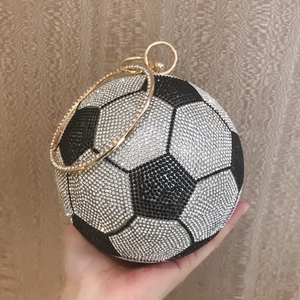 Detail of football clutch bag with crystal rhinestones and gold ring handle