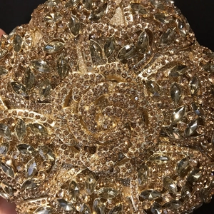 Golden flower-shaped evening clutch bag with sparkling diamonds and intricate 3D rose design