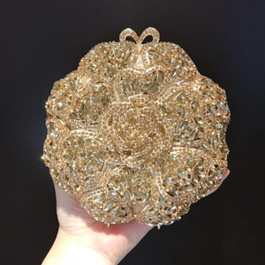 Detail of flower shaped evening clutch with champagne crystals and bow clasp