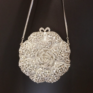 Silver round floral evening clutch bag with sparkling rhinestones and bow clasp
