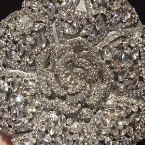 Luxury silver evening clutch bag featuring intricate floral rhinestone and crystal patterns