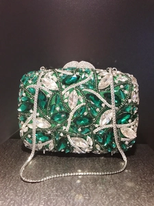 Macro detail of luxury dinner clutch with green and white marquise-cut crystal embellishments