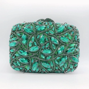 Close-up of emerald green crystal encrusted formal evening clutch bag with metal frame
