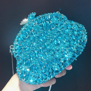 Detailed close-up of sapphire blue evening clutch featuring hand-held marquise cut crystals