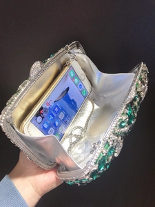Detailed view of the silver evening clutch interior with green marquise crystals