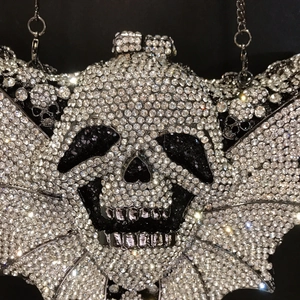Sparkling bat wing and skull evening clutch bag with silver rhinestones and metal chain