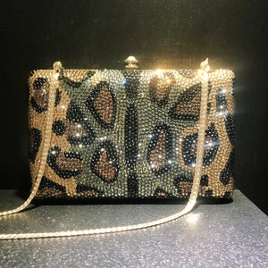 Luxury leopard pattern rhinestone evening bag with gold chain and ball clasp on black background
