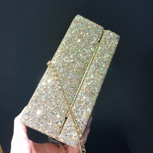 Elegant gold sequin evening clutch bag with metal chain strap for parties and weddings