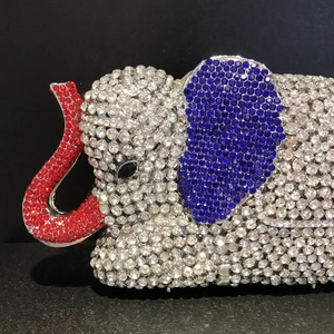 Close-up of elephant clutch bag with red, blue and white crystal rhinestones