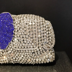 Macro detail of elephant evening clutch with shimmering crystals and blue rhinestones