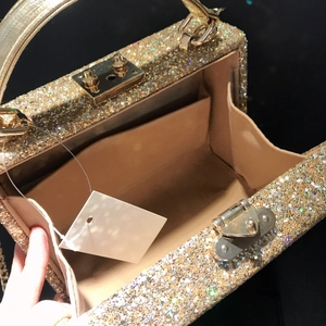 Sparkling gold sequin square handbag with metallic chain and spacious interior