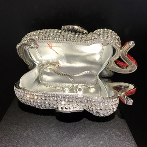 Macro view of crystal encrusted elephant evening clutch showing silver lining and chain