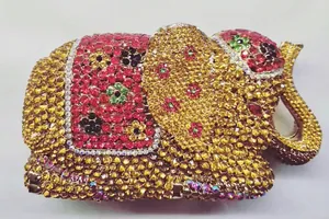 Detailed view of the 3D elephant evening bag with red and gold crystals and floral accents