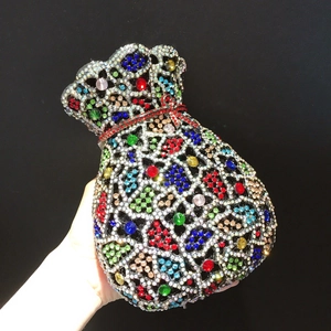 Détail de strass colorés sur une pochette de soirée luxueuse en métal évidé
