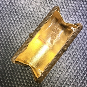 Luxurious gold rhinestone evening clutch bag with chain strap and shiny interior