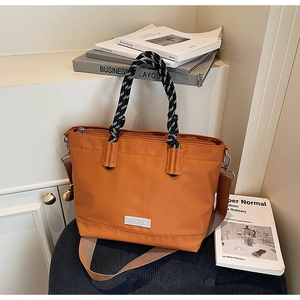 Détail du sac cabas orange en tissu Oxford avec poignées en corde et bandoulière large
