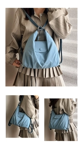 Detail view of morandi blue pleated tote bag showing soft nylon texture and strap design
