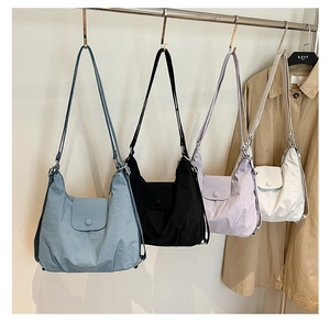 Detail of multi-color nylon hobo bags with adjustable straps and pleated texture
