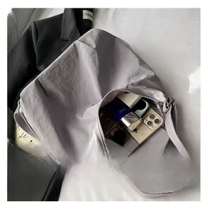 Interior detail of large nylon crossbody bag showing spacious capacity for daily items