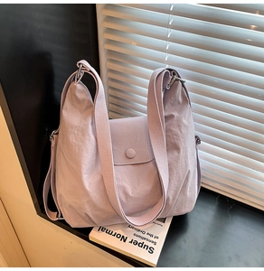 Detail der hellvioletten Nylon-Umhängetasche mit verstellbarem Gurt und Strukturstoff