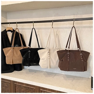 Four colors of large suede tote bags featuring decorative shoulder straps and spacious design