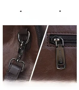 Detailed close-up of gun-metal hardware and zipper on dark brown embossed leather bag