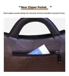 Detail view of the rear anti-theft zipper pocket on a brown embossed leather shoulder bag